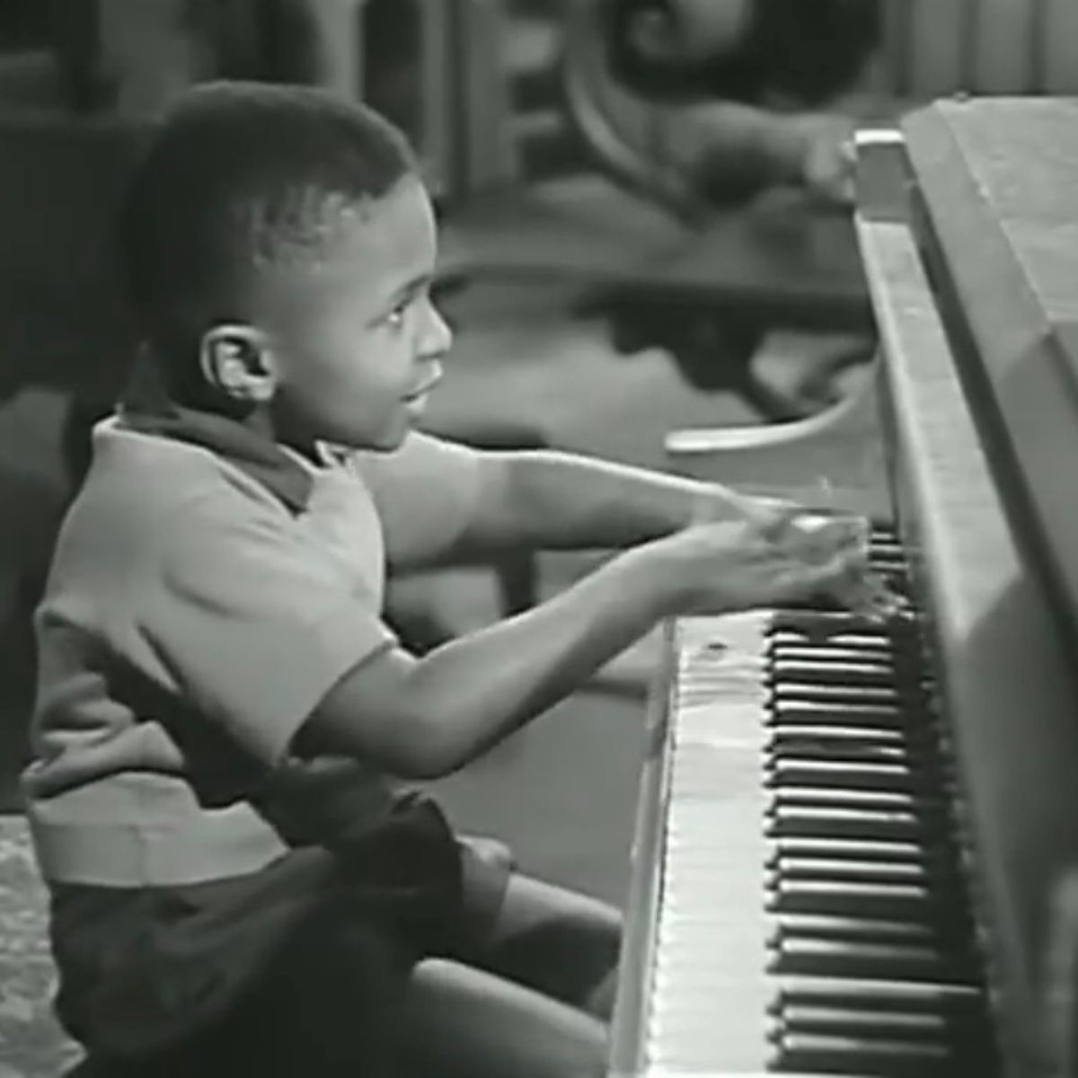 black kid playing piano