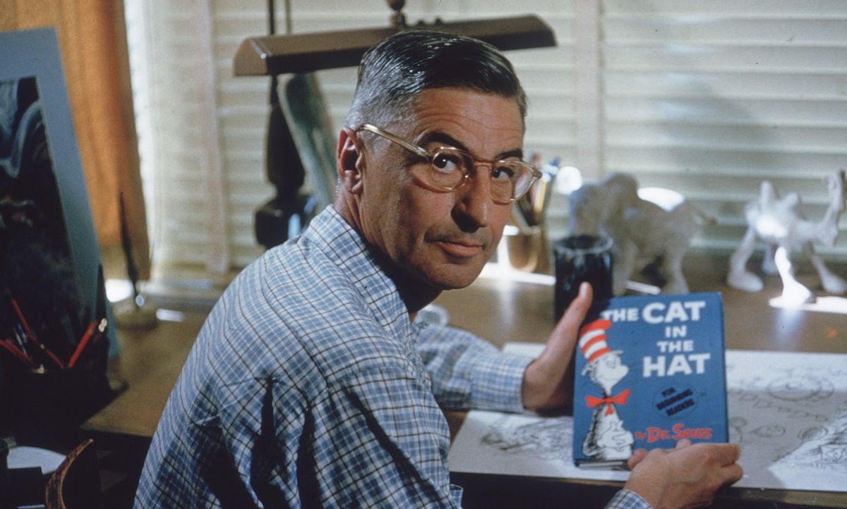 American author and illustrator Dr Seuss (Theodor Seuss Geisel, 1904 - 1991) sits at his drafting table in his home office with a copy of his book, 'The Cat in the Hat', La Jolla, California, April 25, 1957.  (Photo by Gene Lester/Getty Images) (Getty Images)
