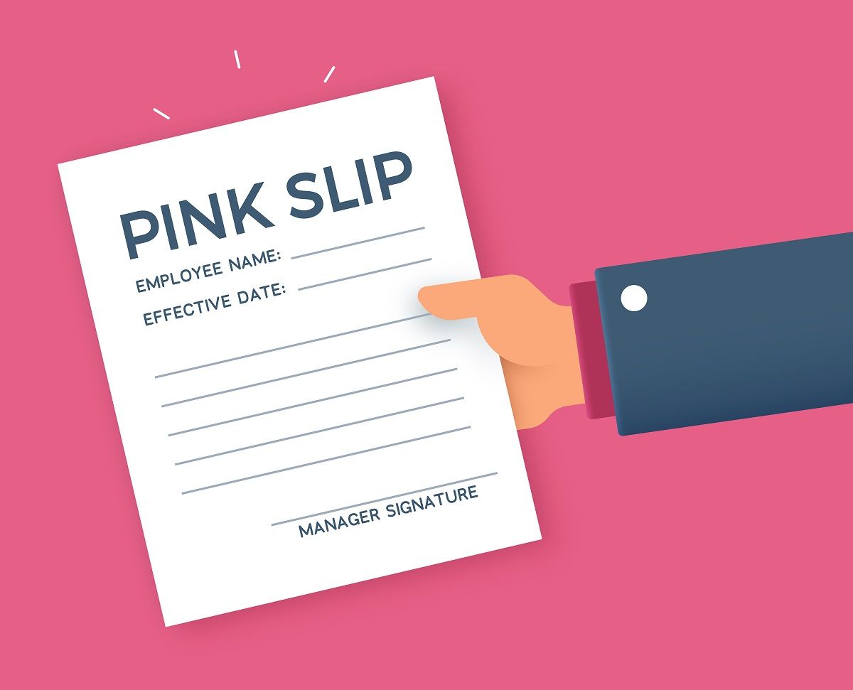 Hand holding pink slip firing from a job termination or layoff document. (Getty Images)