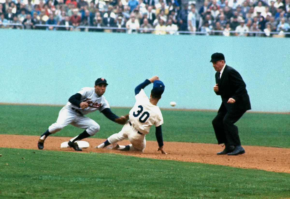 LOS ANGELES - OCTOBER 1965:  Zoilio Versalles #2 of the Minnesota Twins waits for the throw as Maury Wills #30 of the Los Angeles Dodgers slides into second base during the World Series at Dodger Stadium on October 1965 in Los Angeles, Calfornia. (Photo by Focus On Sport/Getty Images) (Focus On Sport/Getty Images)