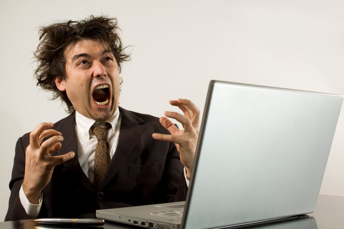 a business man screaming isolated on white. bad news? (Getty Images, stock)
