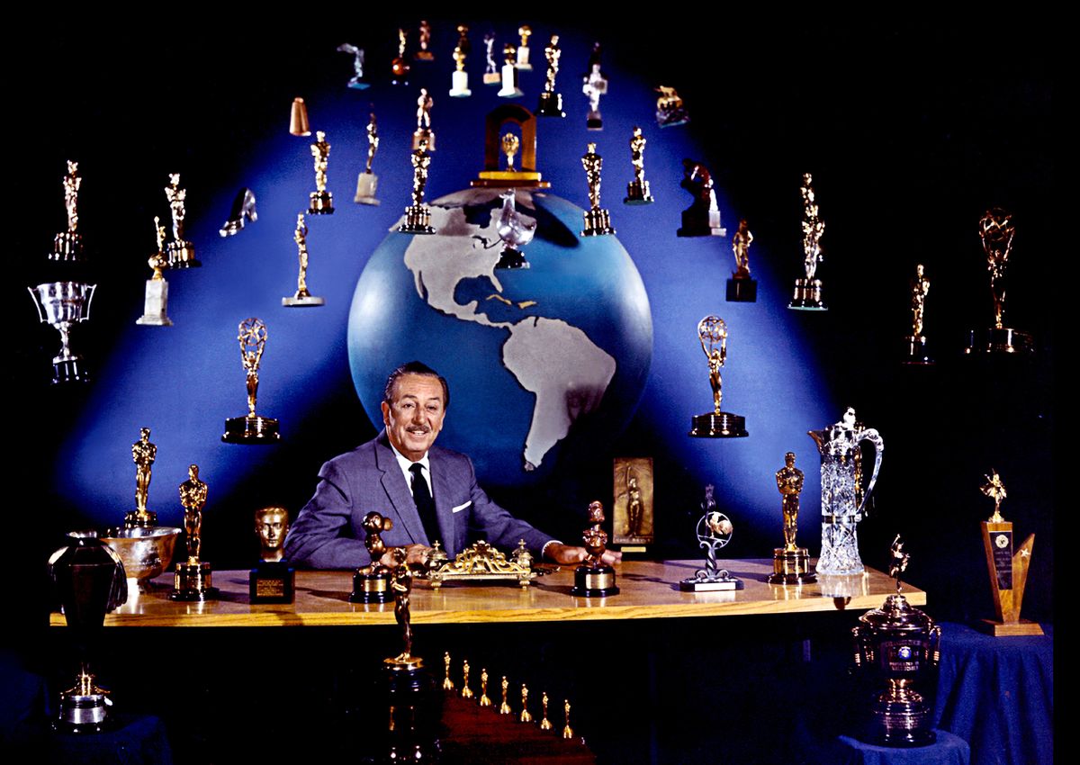 Portrait of American film producer and studio executive Walt Disney (1901 - 1966) as he sits at his desk, Burbank, California, January 1963. A number of trophies, awarded to him and his films, have been arranged around him, many suspended from wires. (Photo by Tom Nebbia/Corbis via Getty Images) (Tom Nebbia/Corbis via Getty Images)