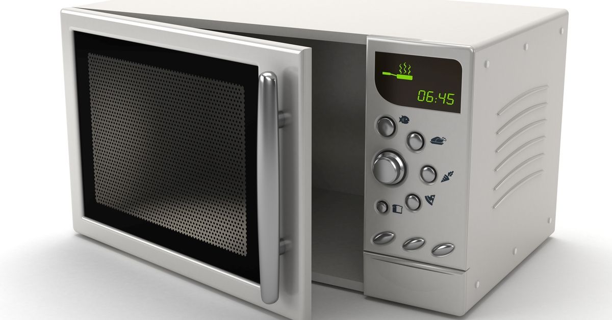 Microwave oven with half-open cover isolated on white.Similar images: (Getty Images/Stock photo)