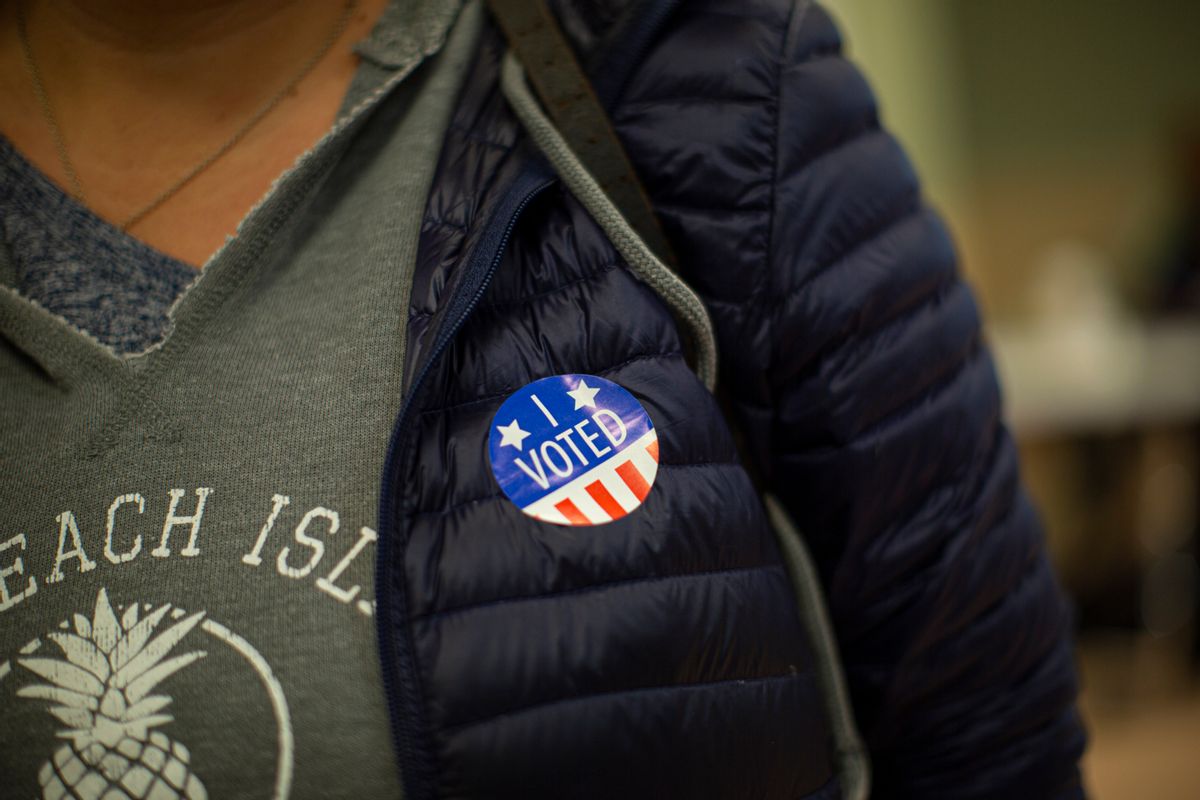 JERSEY CITY, NJ - NOVEMBER 05: A woman wears a sticker after she cast her vote at a polling station on November 5, 2019 in Jersey City, New Jersey. Voters will decide on a ballot measure to regulate the short-term rental industry , if approved, the new rules will include creating an annual 60-day cap and current hosts would also have to obtain permits from the city.  (Photo by Kena Betancur/Getty Images)