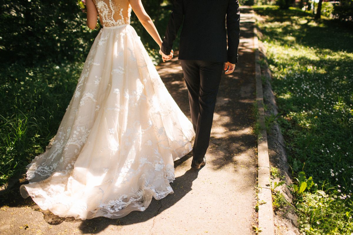 Bride and groom walking on pavements (Getty Images)