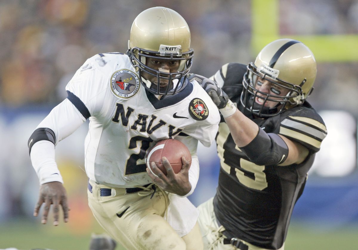 Army Cadet defensive back Caleb Campbell (13) makes an unsuccessful attempt to bring down Navy Midshipmen quarterback Lamar Owens (2) before making it to the endzone Saturday, December 3, 2005 at Lincoln Financial Field in Philadelphia, PA. (Photo by Drew Hallowell/Getty Images) (Drew Hallowell/Getty Images)