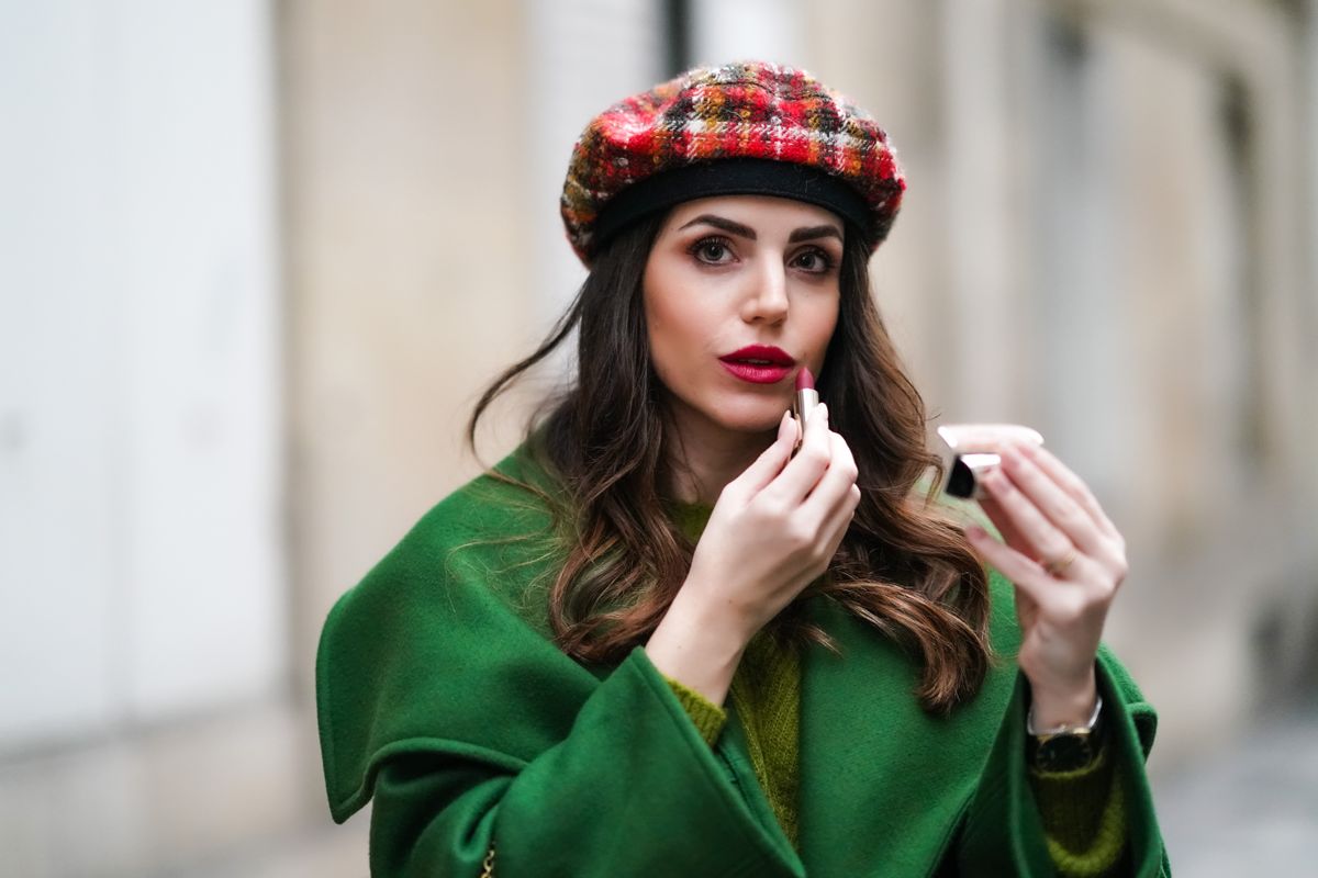 PARIS, FRANCE - NOVEMBER 11: Sara Carnicella wears a green long coat with large oversized lapels from Natan, a green wool pullover from Natan, a red checked wool beret hat from Anthony Peto, a golden chain necklace from APM Monaco, Guerlain red lipstick, on November 11, 2020 in Paris, France. (Photo by Edward Berthelot/Getty Images) (Getty Images)