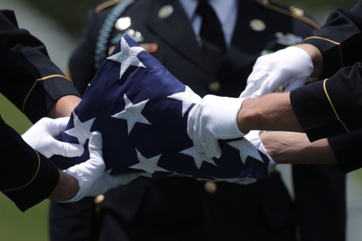 ARLINGTON, VIRGINIA - JUNE 06:  Members of the U.S. Army's 3rd Infantry Regiment "The Old Guard" fold a flag during the funeral of World War II Army veteran Carl Mann on the 75th anniversary of the D-Day invasion June 6, 2019 at Arlington National Cemetery in Arlington, Virginia. Mann, a native of Indiana, was among the troops who stormed Omaha Beach on D-Day during the amphibious landings at Normandy, France. Mann was awarded with seven Bronze Stars and three Purple Hearts throughout his years of military service as a member of the U.S. Third Army.   (Photo by Alex Wong/Getty Images) (Alex Wong/Getty Images)