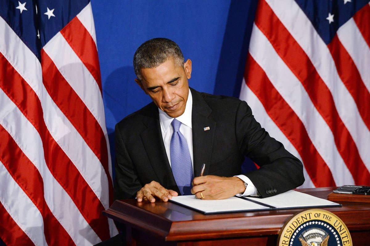 WASHINGTON, DC - OCTOBER 17: (AFP OUT) U.S. President Barack Obama signs the new BuySecure Initiative that direct the government to lead by example in securing transactions and sensitive data on October 17, 2014 in Washington, DC. The new Executive Order will provide consumers with more tools to secure their financial future by assisting victims of identity theft, improving the Government's payment security as a customer and a provider, and accelerating the transition to stronger security technologies and the development of next-generation payment security tools. (Photo by Olivier Douliery-Pool/Getty Images)