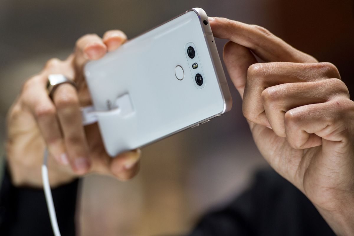 A visitor takes a picture with the Dual rear-facing cameras located on the back of a LG G6 smartphone, manufactured by LG Electronics Inc. during the Mobile World Congress on the third day of the MWC in Barcelona, on March 1, 2017. 
Phone makers will seek to seduce new buyers with artificial intelligence functions and other innovations at the world's biggest mobile fair starting today in Spain. / AFP PHOTO / Josep LAGO        (Photo credit should read JOSEP LAGO/AFP/Getty Images) (JOSEP LAGO/AFP/Getty Images)