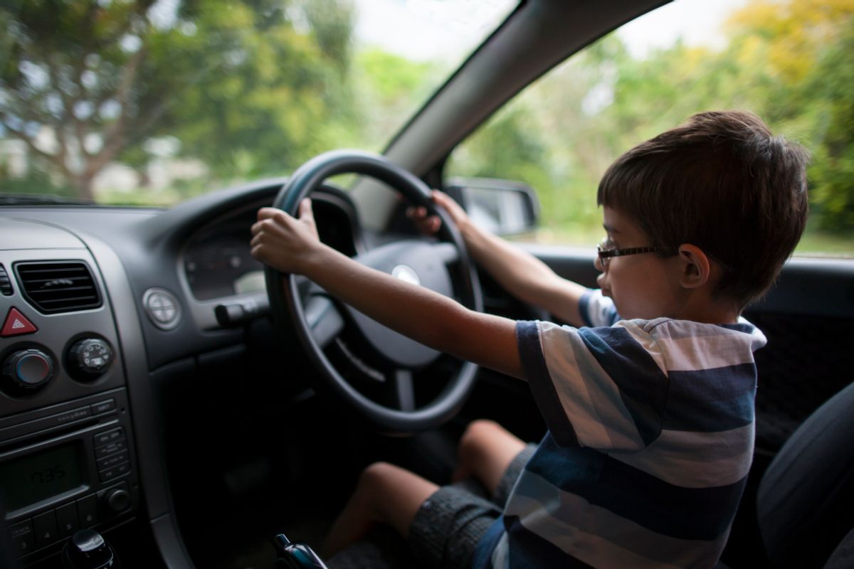 Boy aged 9 sits in driver's seat of parked car and imagines he's driving. (Getty Images/
Donald Iain Smith) (Getty Images/ Donald Iain Smith)
