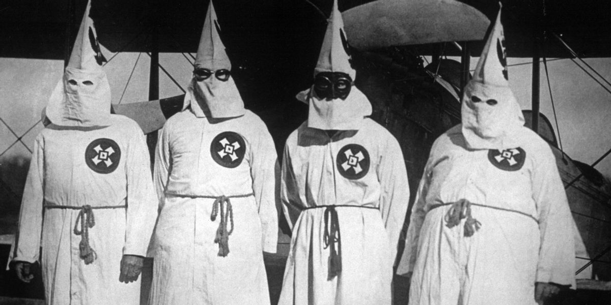 20th March 1922:  Members of the white supremacist movement, the Ku Klux Klan standing by an aeroplane, out of which they dropped publicity leaflets over Washington DC.  (Photo by General Photographic Agency/Getty Images) (Getty Images)
