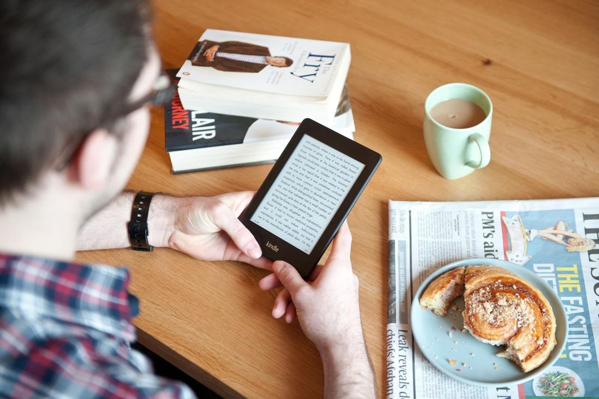 BATH, UNITED KINGDOM - JANUARY 17: A close-up of a man using a Kindle Paperwhite e-reader whilst enjoying morning coffee, January 17, 2013. (Photo by Will Ireland/Future Publishing via Getty Images) (Future Publishing)