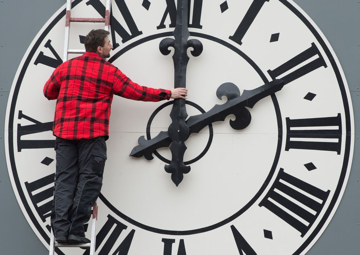 Picture taken on March 23, 2018 shows a technician working on the clock of the Lukaskirche Church in Dresden, eastern Germany. - The European Commission will recommend EU member states abolish daylight saving, where clocks are advanced by one hour in summer, its president Jean-Claude Juncker said on German television on August 31, 2018. (Photo by Sebastian Kahnert / dpa / AFP) / Germany OUT        (Photo credit should read SEBASTIAN KAHNERT/AFP/Getty Images) (SEBASTIAN KAHNERT/AFP/Getty Images)