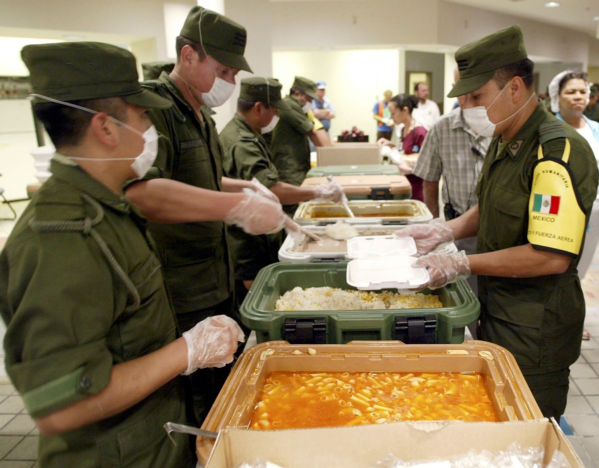 SAN ANTONIO - SEPTEMBER 9:  Mexican soldiers prepares plates of food for Hurricane Katrina evacuees at the noon meal September 9, 2005 in San Antonio, Texas. The Mexican Army will be in San Antonio for 20 days to provide humanitarian relief. This is the first time the Mexican Army has been in San Antonio since 1846.  (Photo by Joe Mitchell/Getty Images) (Joe Mitchell/Getty Images)