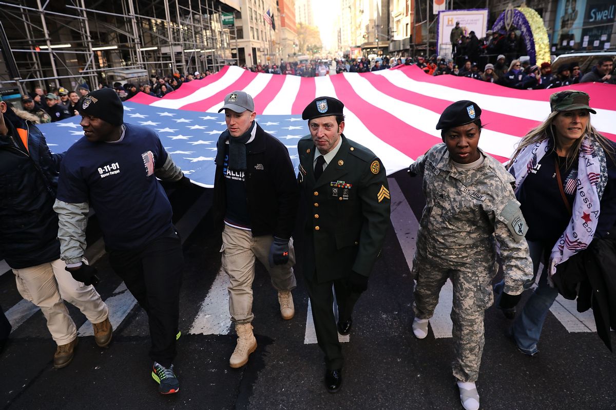 NEW YORK, NY - NOVEMBER 11:  Soldiers, veterans and civilians carry an American Flag as they march in the Veterans Day Parade on November 11, 2017 in New York City. The largest Veterans Day event in the nation, this year's parade features thousands of marchers, including military units, civic and youth groups, businesses and high school bands from across the country and veterans of all eras. The U.S. Air Force is this year's featured service and the grand marshal is space pioneer Buzz Aldrin.  (Photo by Spencer Platt/Getty Images) (Spencer Platt/Getty Images, file)