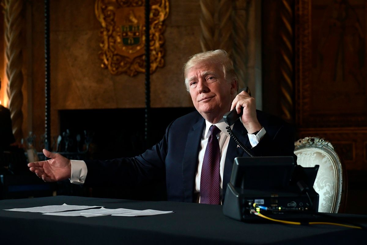 President Donald Trump asks if reporters can hear the audio as he talks with troops via teleconference from his Mar-a-Lago estate in Palm Beach, Fla., Thursday, Nov. 22, 2018. (AP Photo/Susan Walsh) (AP Photo/Susan Walsh)