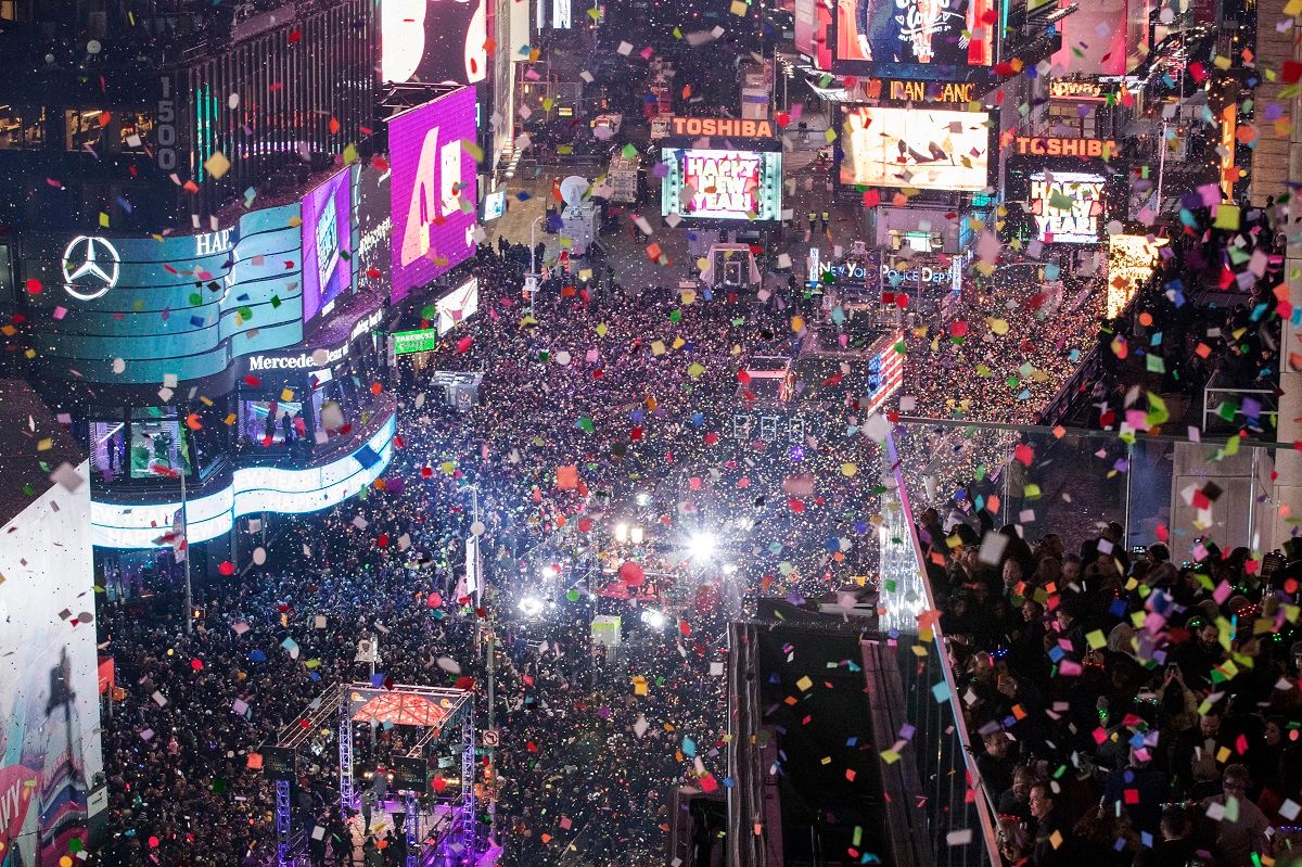 FILE - In this Jan. 1, 2017 file photo, revelers celebrate the new year as confetti flies over New York's Times Square. Year after year, people watching New York City's New Year's Eve celebration are told by city dignitaries and TV personalities that they are watching a million people gathered in Times Square. The AP asks experts whether it is actually possible to fit that many people into the viewing areas. (AP Photo/Mary Altaffer, File) (AP Photo/Julio Cortez)