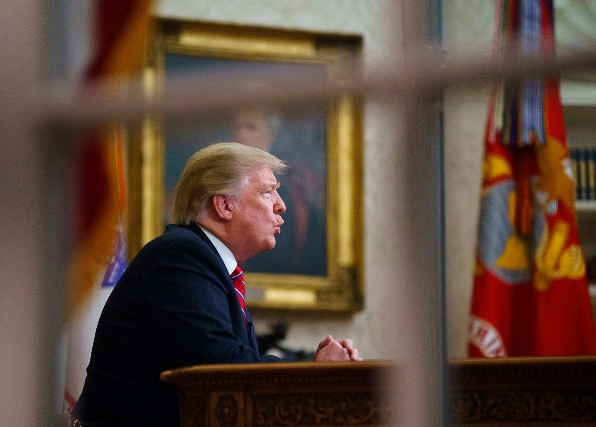 As seen from a window outside the Oval Office, President Donald Trump gives a prime-time address about border security Tuesday, Jan. 8, 2018, at the White House in Washington. (AP Photo/Carolyn Kaster) (AP Photo/Carolyn Kaster)