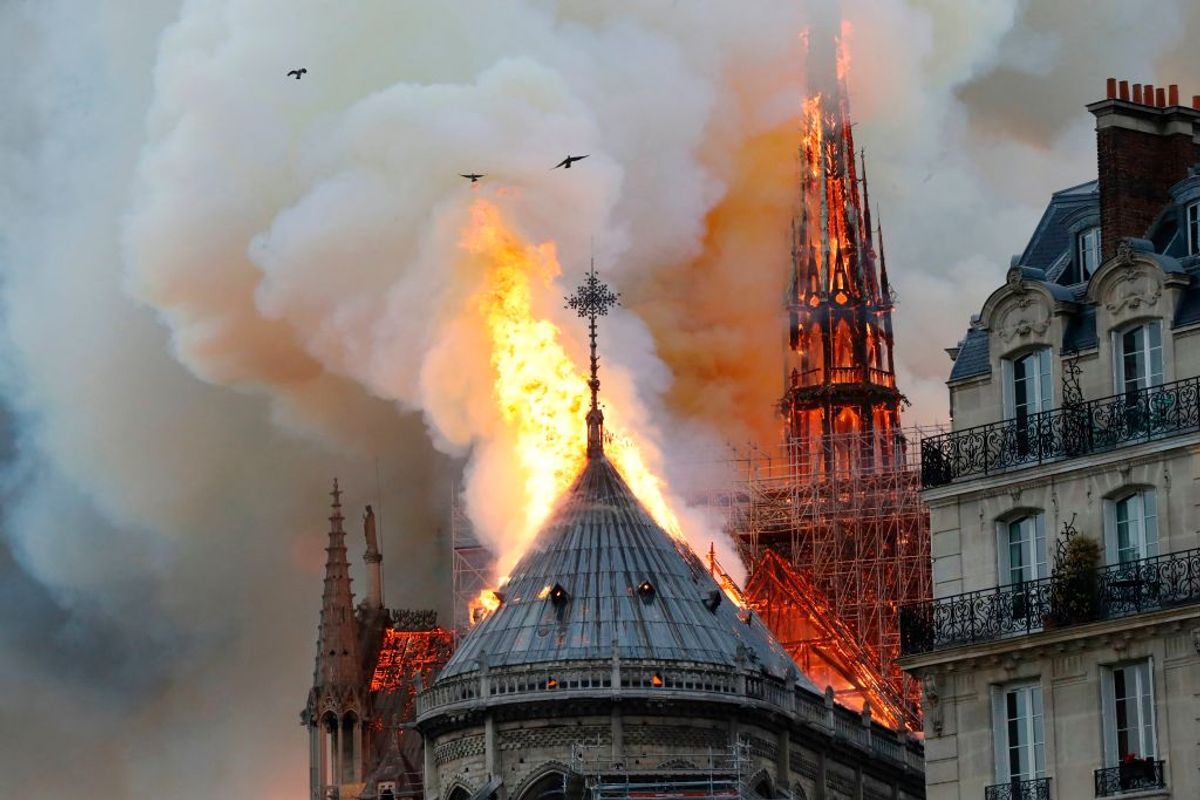 TOPSHOT - Smoke and flames rise during a fire at the landmark Notre-Dame Cathedral in central Paris on April 15, 2019, potentially involving renovation works being carried out at the site, the fire service said. (Photo by FRANCOIS GUILLOT / AFP)        (Photo credit should read FRANCOIS GUILLOT/AFP/Getty Images) (Getty Images)