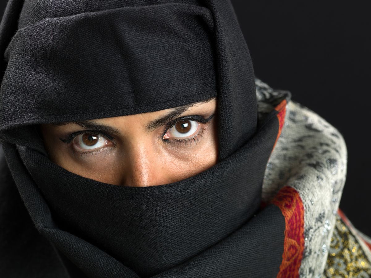 close up picture of a forty something middle eastern Muslim housewife wearing a veil on black background (this picture have been shot with a Hasselblad HD3 II 31 megapixels) (Getty Images)