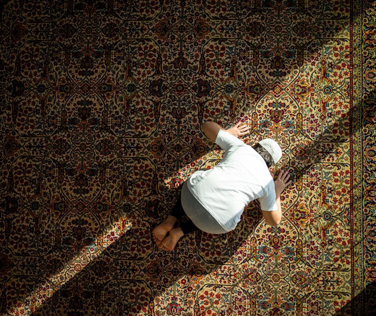 Muslim kid praying inside mosque (Getty Images)