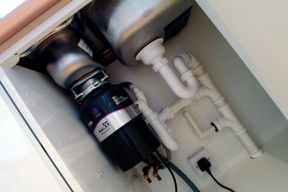 Waste disposal unit under sink. (Photo by Geoff Doran/Construction Photography/Avalon/Getty Images) (Getty Images)