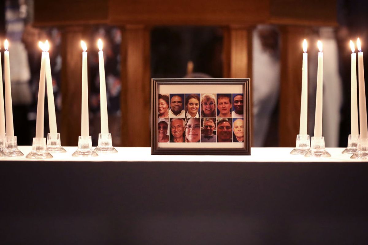 VIRGINIA BEACH, VIRGINIA - JUNE 02: A photograph of the victims of a mass shooting is surrounded by 12 candles during a memorial service at Piney Grove Baptist Church June 02, 2019 in Virginia Beach, Virginia. Eleven city employees and one private contractor were shot to death Friday in the Municipal Center Operations building by engineer DeWayne Craddock who had worked for the city for 15 years. (Photo by Chip Somodevilla/Getty Images) (Getty Images)
