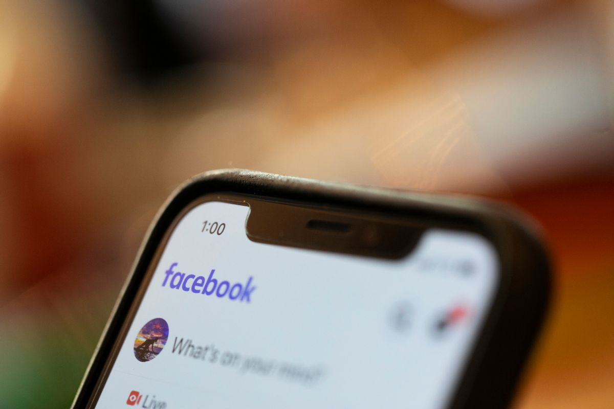 In this Sunday, Aug. 11, 2019, photo an iPhone displays a Facebook page in New Orleans.  Facebook says it paid contractors to transcribe audio clips from users of its Messenger service. (AP Photo/Jenny Kane) (AP Photo/Jenny Kane)
