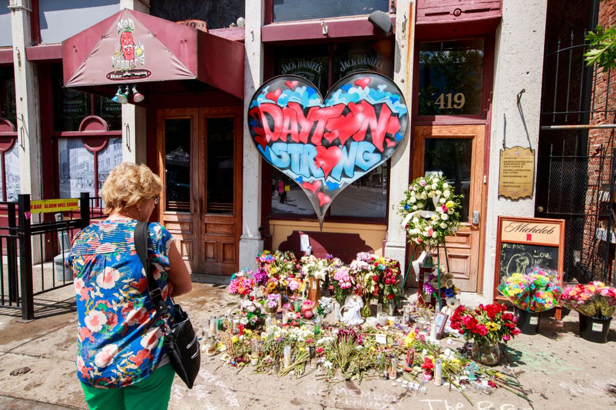 DAYTON, OHIO, UNITED STATES - 2019/08/07: A woman stops to look at a memorial on 5th Street at the site of Sunday morning's mass shooting that left 9 dead, and 27 wounded, Wednesday, August 7, 2019 in Dayton, Ohio.
Trump visited a nearby hospital but did not visit the site of the shooting before flying to El Paso, Texas, which was also the site of a mass shooting. (Photo by Jeremy Hogan/SOPA Images/LightRocket via Getty Images) (Getty Images)