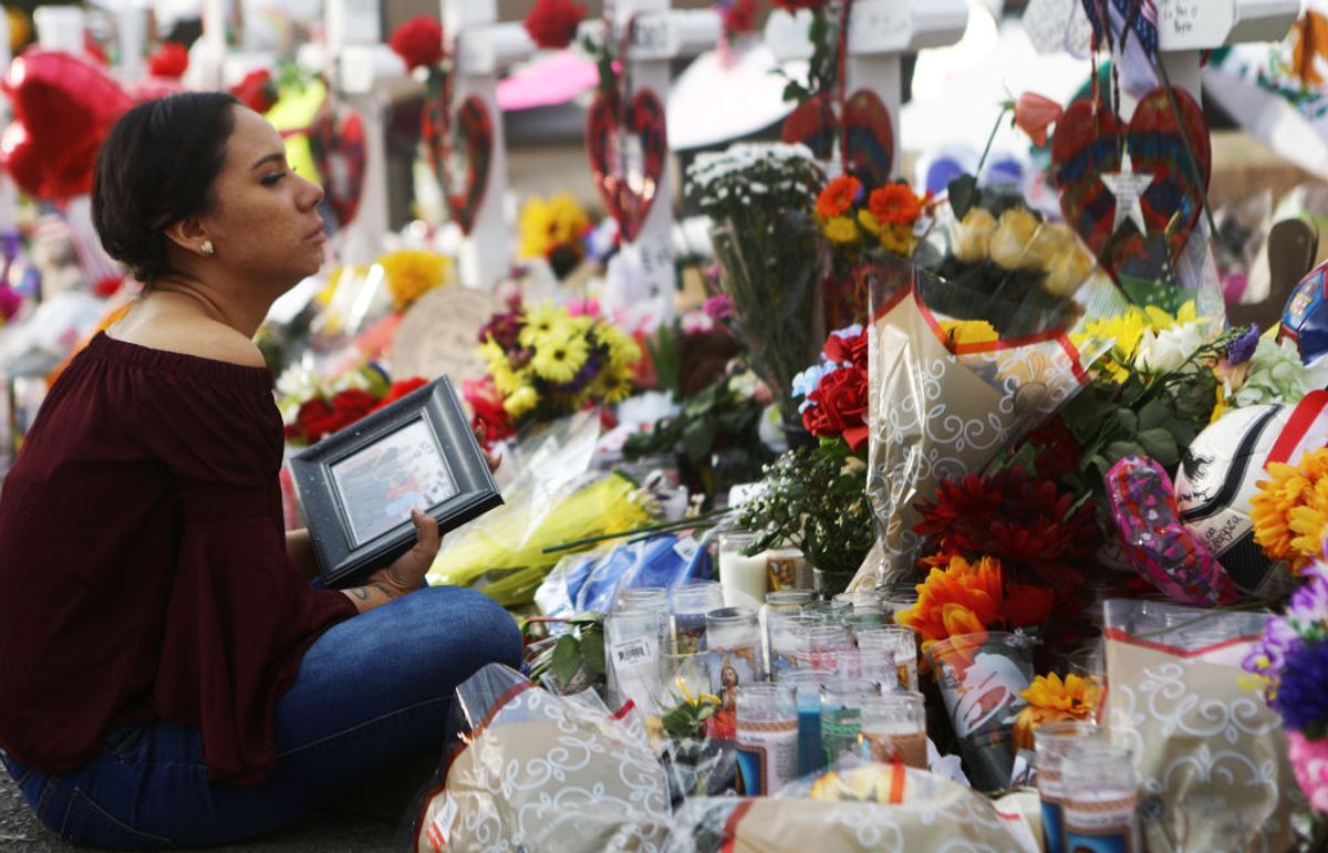 EL PASO, TEXAS - AUGUST 06: Yamileth Lopez holds a photo of her deceased friend Javier Amir Rodriguez at a makeshift memorial for victims outside Walmart, near the scene of a mass shooting which left at least 22 people dead, on August 6, 2019 in El Paso, Texas.  Rodriguez was a sophomore at Horizon High School and was killed in the shooting. A 21-year-old white male suspect remains in custody in El Paso, which sits along the U.S.-Mexico border. President Donald Trump plans to visit the city August 7.  (Photo by Mario Tama/Getty Images) (Mario Tama/Getty Images)