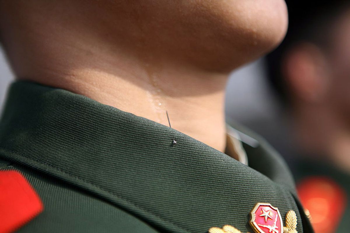 A pin, used for training purposes, is placed on the collar of a Chinese paramilitary policeman undergoing a drill to prepare for the upcoming National People's Congress (NPC) in Beijing on February 28, 2012.  China's parliament, the National People's Congress, is set to open its annual session on March 5.        CHINA OUT      AFP PHOTO (Photo credit should read STR/AFP/Getty Images) (Getty Images)