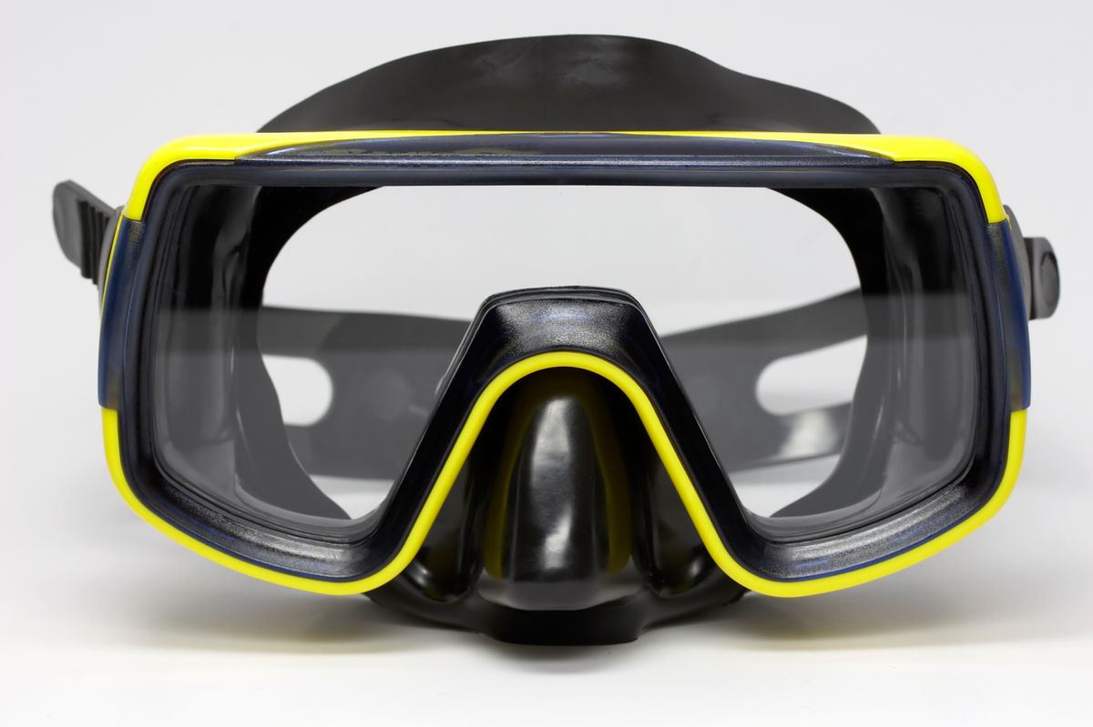 Black diving mask with yellow border. Isolated, studio shot. (Getty Images)