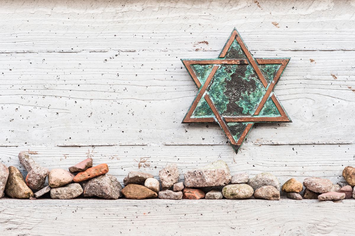 Small stone pebbles placed as an act of remembrance and respect below the Star of David. (Getty Images)