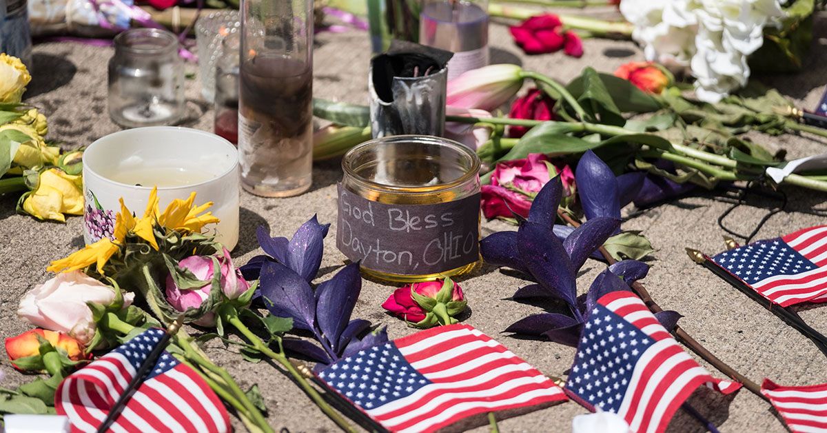 Candles and flowers a placed in front of Ned Peppers bar after the mass shooting over the weekend in Dayton, Ohio on August 5, 2019. - US President Donald Trump urged Republicans and Democrats to agree on tighter gun control and suggested legislation could be linked to immigration reform after two shootings left 30 people dead and sparked accusations that his rhetoric was part of the problem. "Republicans and Democrats must come together and get strong background checks, perhaps marrying this legislation with desperately needed immigration reform," Trump tweeted as he prepared to address the nation on two weekend shootings in Texas and Ohio. "We must have something good, if not GREAT, come out of these two tragic events!" Trump wrote. (Photo by Megan JELINGER / AFP) (MEGAN JELINGER/AFP/Getty Images)