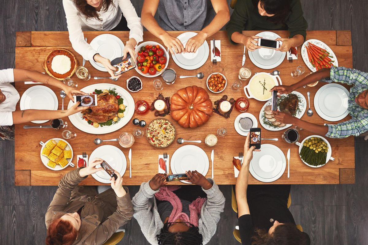 Shot of a group of people sitting together at a dining table ready to eat (Getty Images, stock)