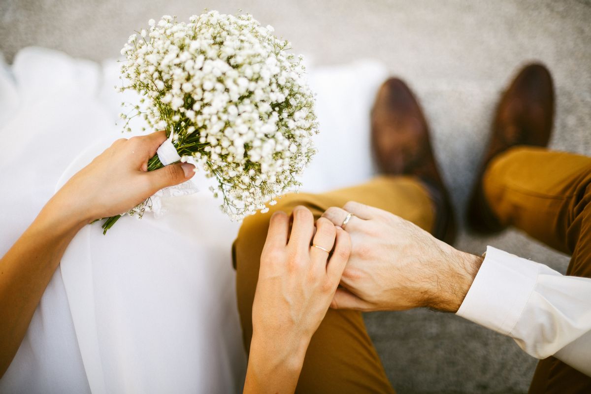 Bride and groom holding their hands together (Getty Images/Stock photo)