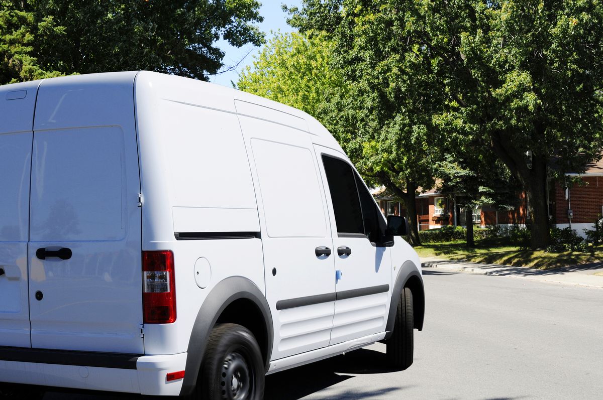 White delivery van in a residential district (Getty Images/Stock photo)