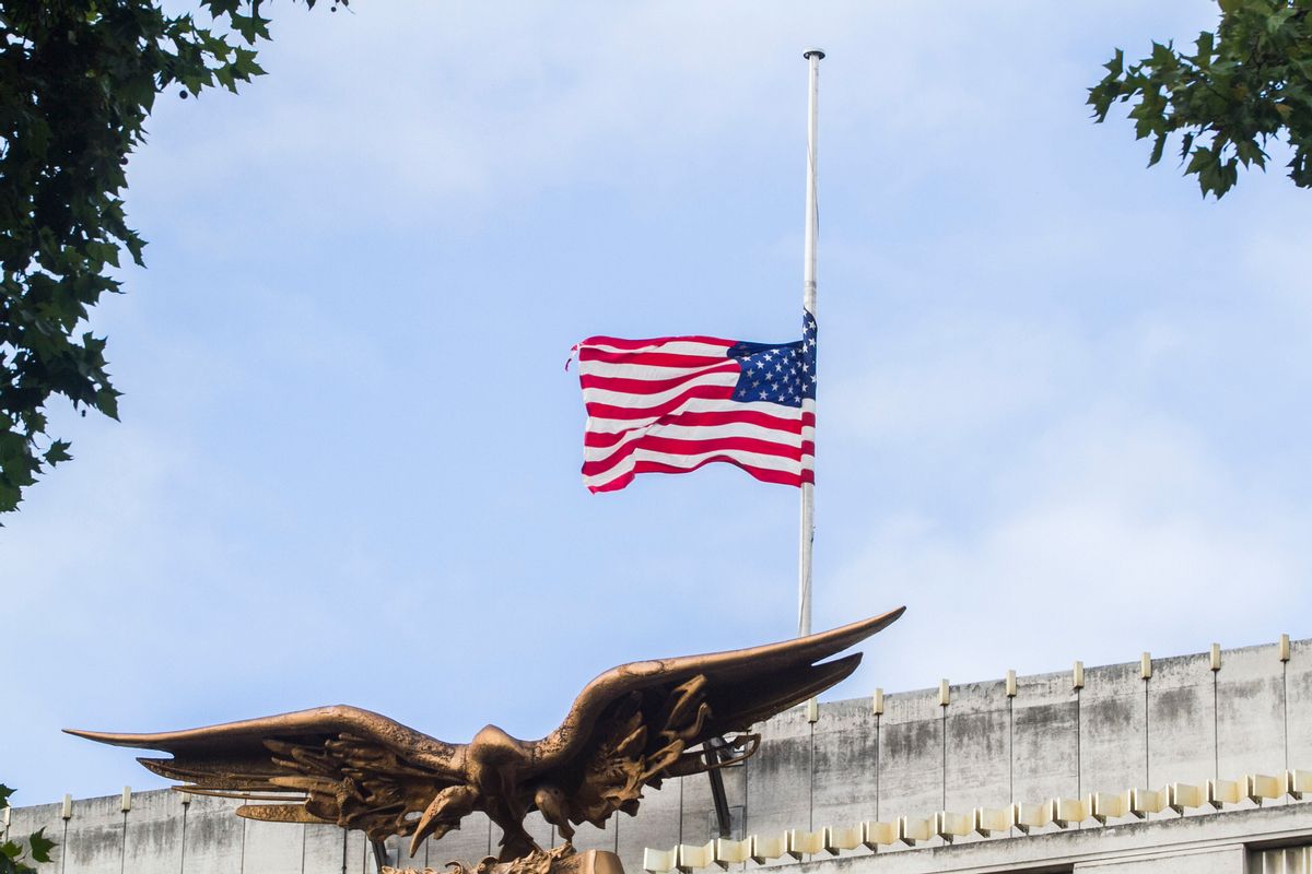Low angle view of American flag  flying at half mast above embassy building on September 11 terrorist attack anniversary (Getty Images/Stock photo)