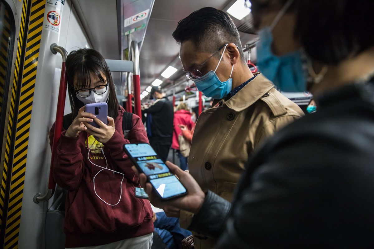People wear masks while commuting on a train in Hong Kong on January 26, 2020, as a preventative measure following a coronavirus outbreak which began in the Chinese city of Wuhan. - Hong Kong on January 25 declared a new coronavirus outbreak as an "emergency" -- the city's highest warning tier -- as authorities ramped up measures to reduce the risk of further infections. (Photo by DALE DE LA REY / AFP) (Photo by DALE DE LA REY/AFP via Getty Images) (DALE DE LA REY/AFP via Getty Images)