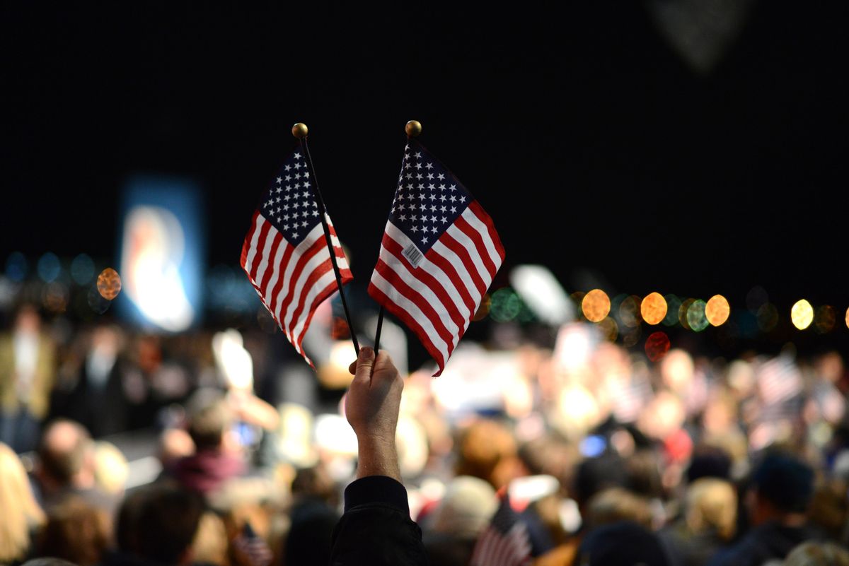 Flags held by a supporter at a political meeting for Mitt Romney in Virginia. (Getty Images/Stock photo)