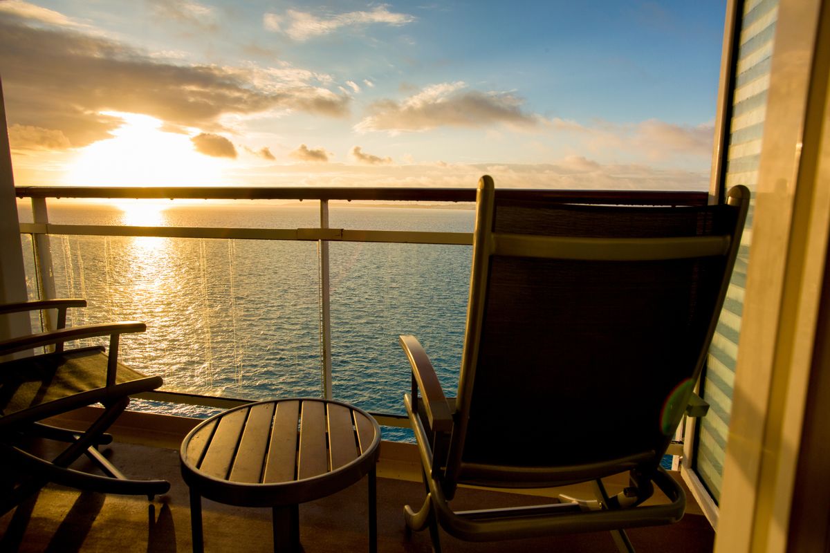 Calm scene of a deck chair at dusk viewing a beautiful sunset from a cruise ship (Getty Images )