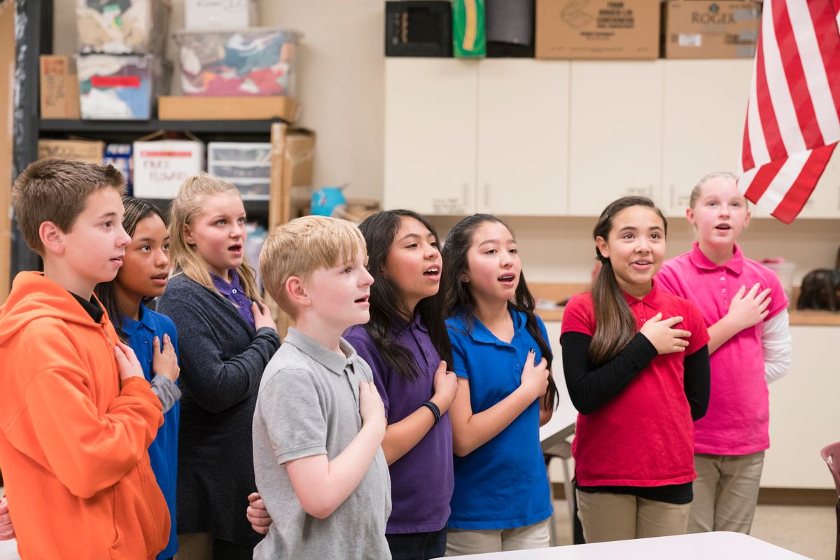 Students standing for Pledge of Allegiance (Getty Images/Stock photo)