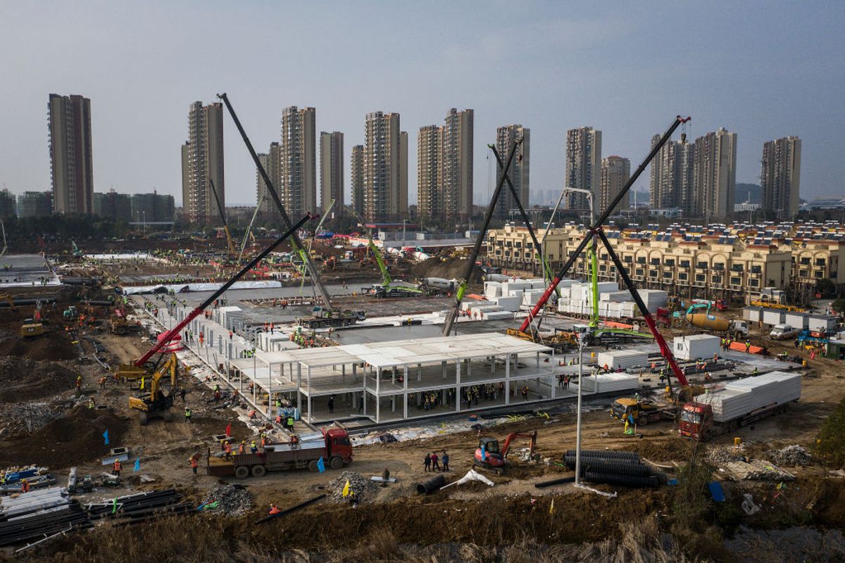 WUHAN, CHINA - JANUARY 28:  (CHINA OUT) Hundreds of construction workers and heavy machinery build new hospitals to tackle the coronavirus on January 28, 2020 in Wuhan, China. Wuhan Huoshenshan hospital will be completed on February 2nd and put into use on February 5th, with the capacity of 1000 beds.  (Photo by Getty Images) (Getty Images)