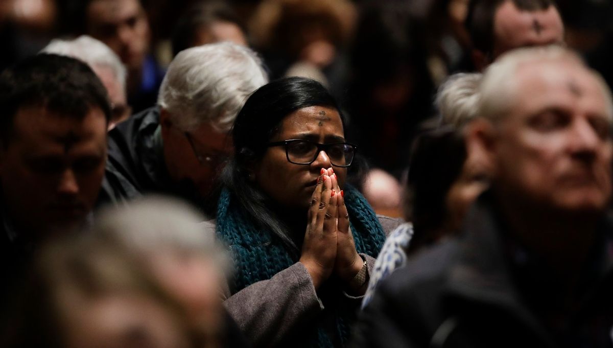 Worshipers pray during an Ash Wednesday Mass at the Cathedral Basilica of Saints Peter and Paul in Philadelphia, Wednesday, March 6, 2019. Ash Wednesday marks the beginning of Lent, a time when Christians prepare for Easter through acts of penitence and prayer. (AP Photo/Matt Rourke) (Matt Rourke / Associated Press)
