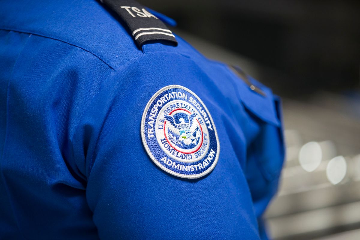 MIAMI, FLORIDA - MAY 21: A Transportation Security Administration (TSA) agent's patch is seen as she helps travelers place their bags through the 3-D scanner at the Miami International Airport on May 21, 2019 in Miami, Florida. TSA has begun using the new 3-D computed tomography (CT) scanner in a checkpoint lane to detect explosives and other prohibited items that may be inside carry-on bags.  (Photo by Joe Raedle/Getty Images) (Joe Raedle/Getty Images)