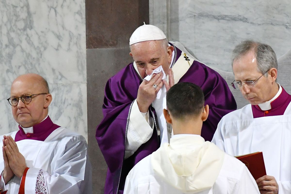 Pope Francis wipes his nose during the Ash Wednesday mass which opens Lent, the forty-day period of abstinence and deprivation for Christians before Holy Week and Easter, on February 26, 2020, at the Santa Sabina church in Rome. - Pope Francis postponed his official appointments on February 28 and was working from home, the Vatican said, a day after cancelling a scheduled appearance at mass because of "a mild ailment". Francis, 83, had appeared earlier in the week to be suffering from a cold. He was seen blowing his nose and coughing during the Ash Wednesday service, and his voice sounded hoarse. (Photo by Alberto PIZZOLI / AFP) (Photo by ALBERTO PIZZOLI/AFP via Getty Images) (ALBERTO PIZZOLI/AFP via Getty Images)