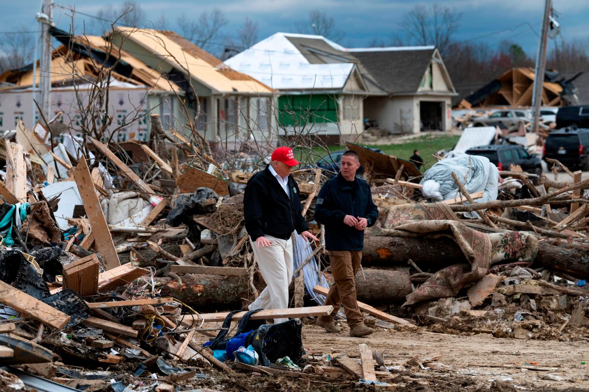 US President Donald Trump tours tornado damage with Putnam County Rescue Squad member Mike Herrick (R) in Cookeville, Tennessee on March 6, 2020. - At least 24 are dead in the wake of March 3 2020 terrible Tennessee tornadoes. They carved a long scar across Middle Tennessee in the dead of night, racking up a large death toll in the process. While downtown Nashville was hit hard, the town of Cookeville  about 80 miles east of the state capital  suffered the worst of the devastation. (Photo by JIM WATSON / AFP) (Photo by JIM WATSON/AFP via Getty Images) (JIM WATSON/AFP via Getty Images)