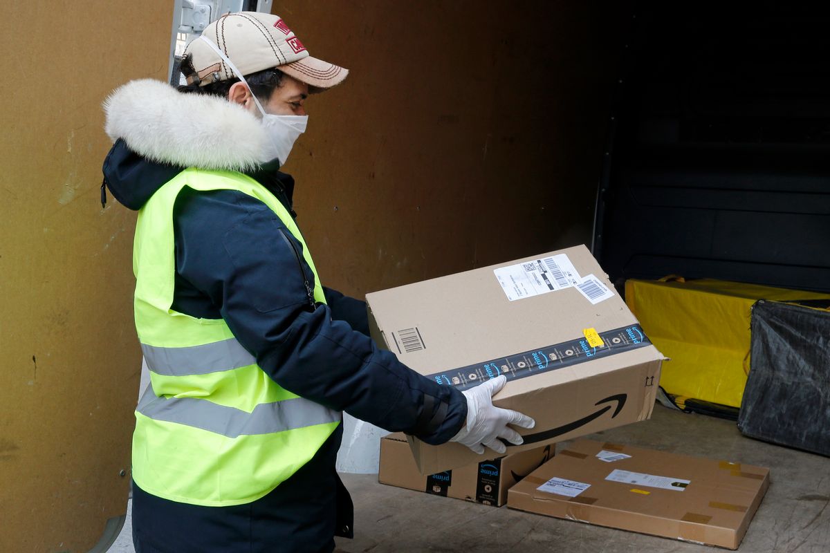 PARIS, FRANCE - MARCH 22: A delivery man wearing a protective mask carries an Amazon package on March 22, 2020 in Paris, France. The U.S. company Amazon has decided to stop all deliveries of "non-essential" orders in France. Coronavirus (Covid-19) has spread to at least 182 countries, claiming over 13,400 lives and infecting more than 312,000 people. In order to combat the outbreak, and during a televised speech dedicated to the coronavirus crisis on March 16, French President, Emmanuel Macron announced that France starts a nationwide lockdown on March 17 at noon. (Photo by Chesnot/Getty Images) (Chesnot/Getty Images, file)