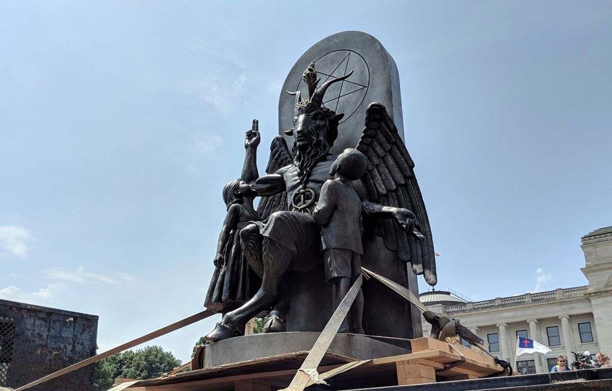 The Satanic Temple unveils its statue of Baphomet, a winged-goat creature, at a rally for the first amendment in Little Rock, Ark., Thursday, Aug. 16, 2018. The Satanic Temple wants to install the statue on Capitol grounds as a symbol for religious freedom after a monument of the Biblical Ten Commandments was installed in 2017. (AP Photo/Hannah Grabenstein) (AP Photo / Hannah Grabenstein)